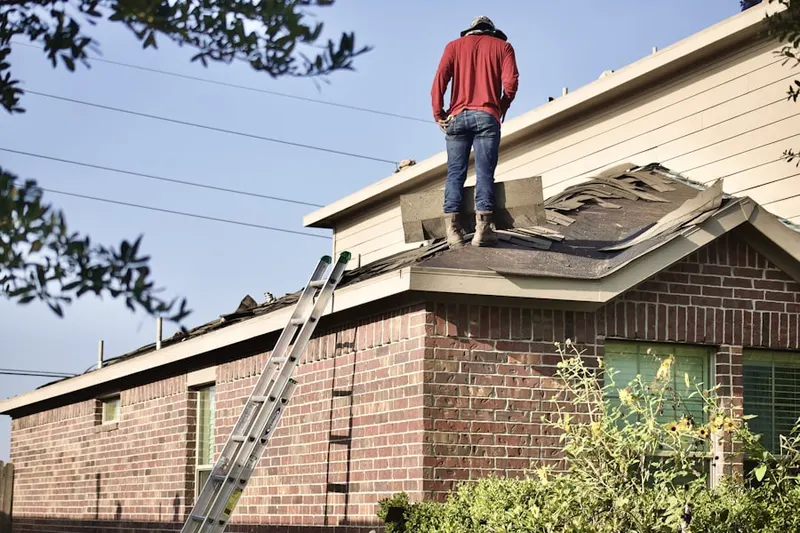 Professional roofer working on a residential roof in Garrett Park